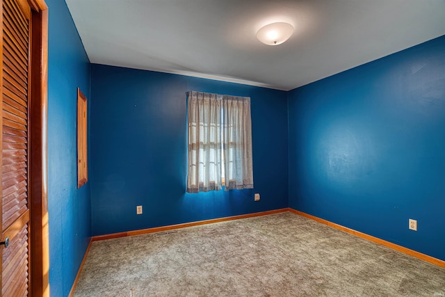 unfurnished room featuring carpet flooring