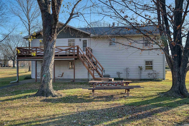 rear view of property featuring a deck and a yard