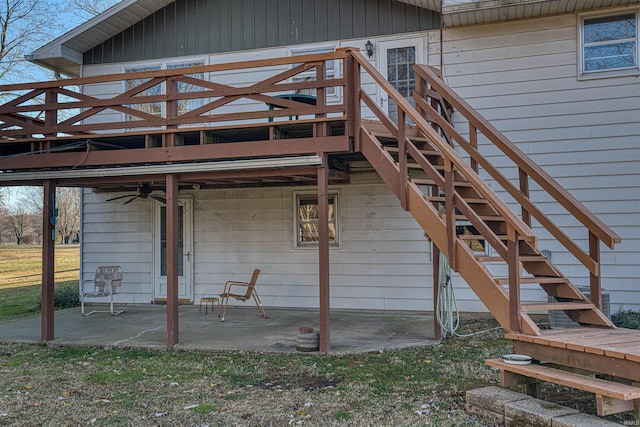 back of property featuring ceiling fan and a patio