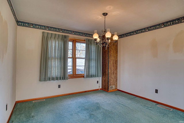 spare room with carpet flooring and a chandelier