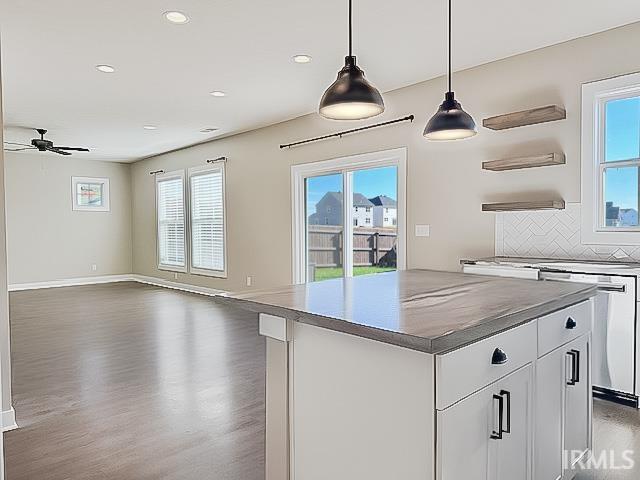 kitchen featuring dishwasher, dark wood-type flooring, ceiling fan, decorative light fixtures, and white cabinetry