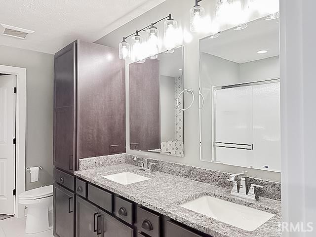 bathroom featuring tile patterned floors, vanity, and toilet