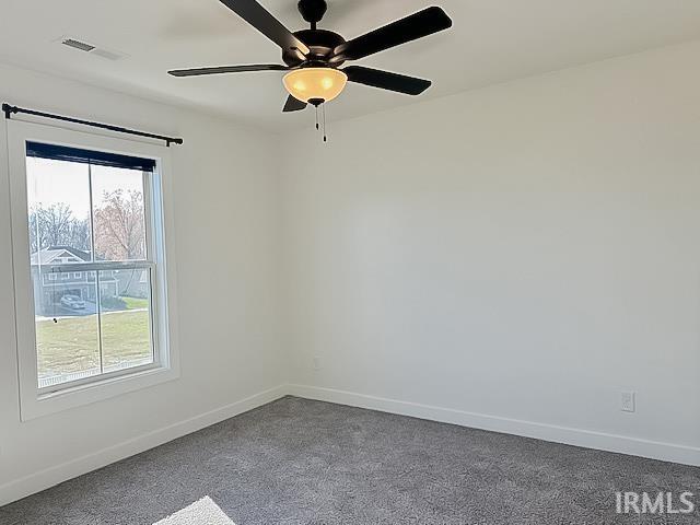 carpeted empty room featuring ceiling fan