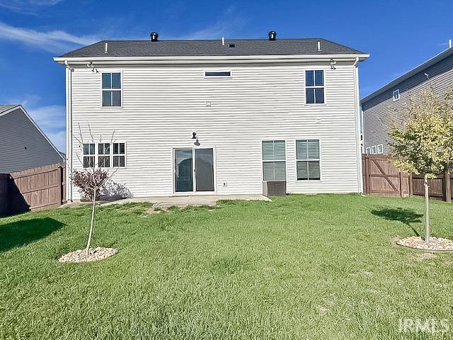 rear view of house with a yard