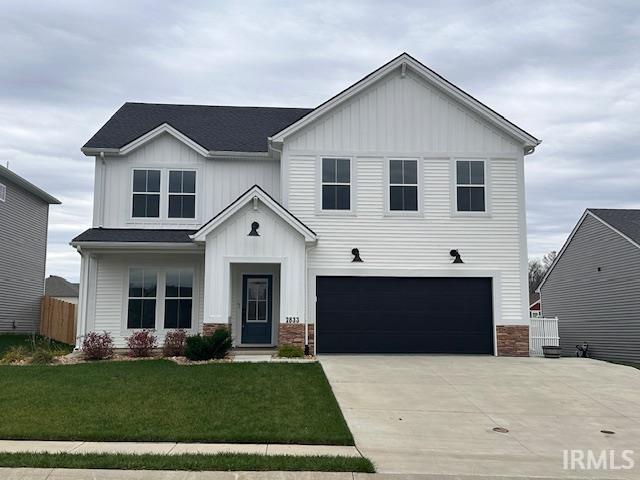 view of front of house with a garage and a front lawn