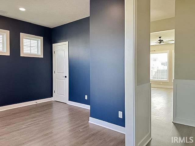 spare room with hardwood / wood-style flooring and ceiling fan