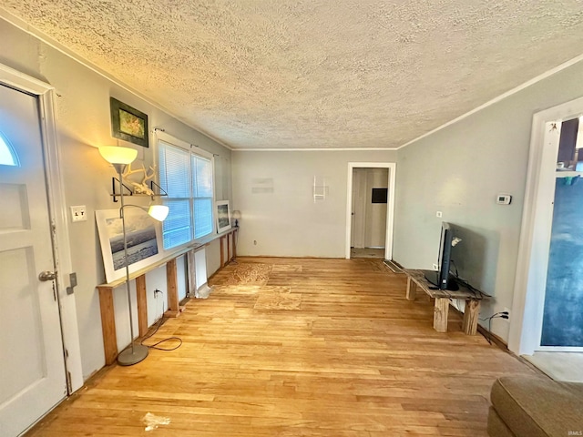 interior space with light hardwood / wood-style floors and a textured ceiling