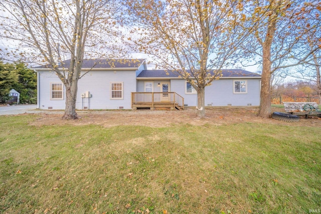 back of property featuring a lawn and a wooden deck