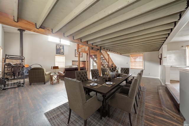 dining space featuring dark hardwood / wood-style flooring and beamed ceiling