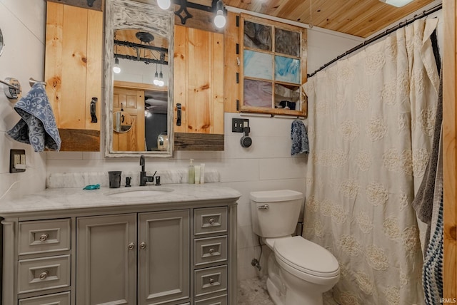 bathroom with vanity, toilet, tile walls, and wooden ceiling