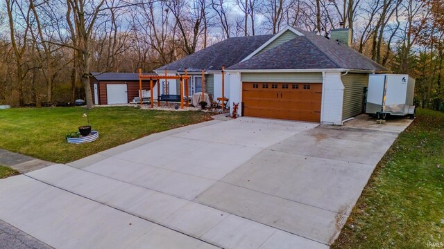 ranch-style home with a garage and a front lawn