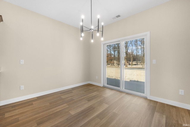 10209 Buckshire Ct, New Haven, IN 46774 - unfurnished dining area featuring wood finished floors, a chandelier, and baseboards