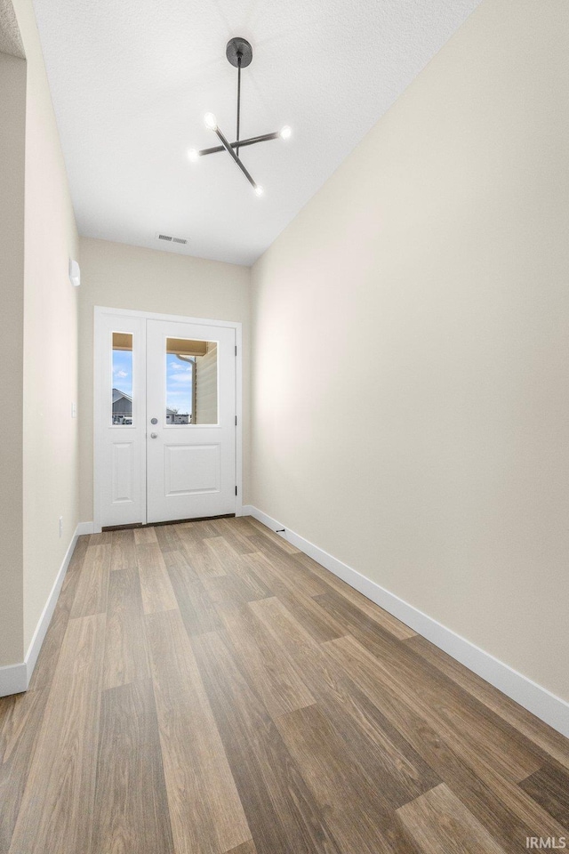 10209 Buckshire Ct, New Haven, IN 46774 - foyer featuring a chandelier, wood finished floors, and baseboards