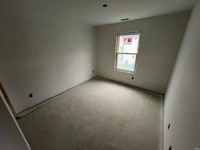 unfurnished room with concrete flooring