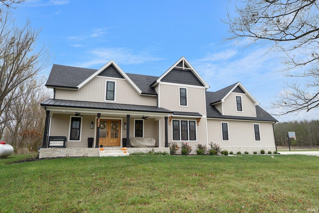 view of front facade with covered porch and a front yard