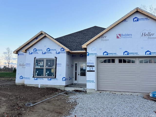 property under construction with a shingled roof and an attached garage