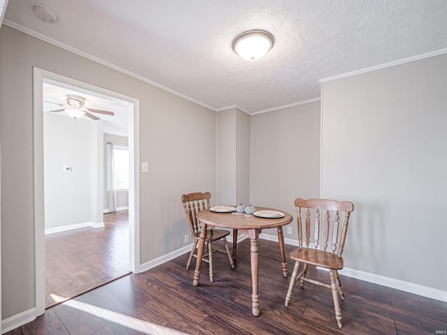 dining area with crown molding, dark hardwood / wood-style flooring, ceiling fan, and a textured ceiling