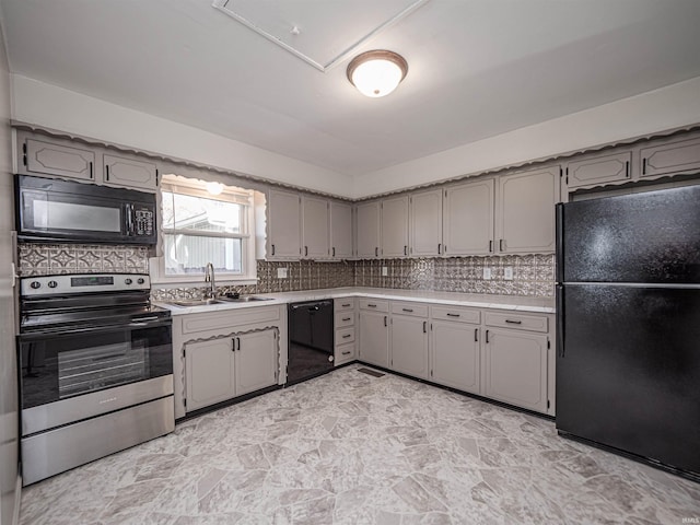 kitchen featuring black appliances, gray cabinets, and sink