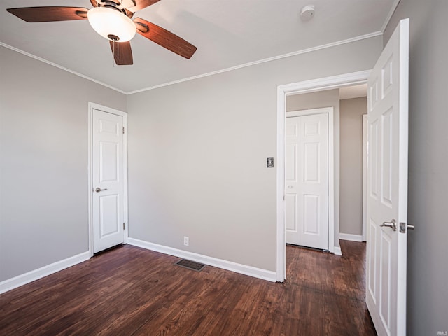 spare room featuring dark hardwood / wood-style floors, ceiling fan, and ornamental molding