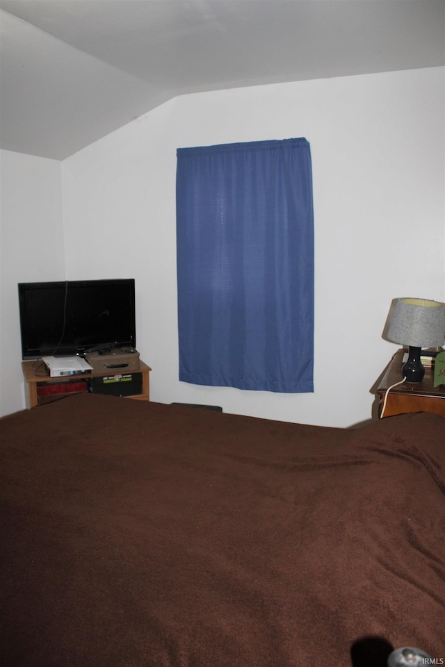 carpeted bedroom with vaulted ceiling