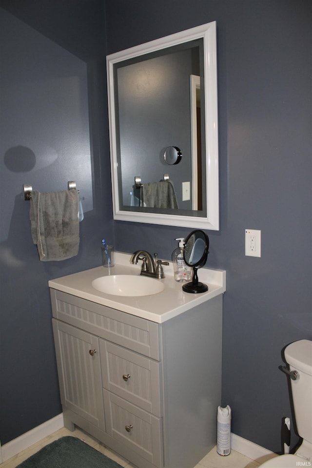 bathroom featuring vanity and toilet