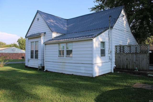 back of property featuring a lawn