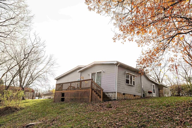 view of property exterior featuring a wooden deck and a yard