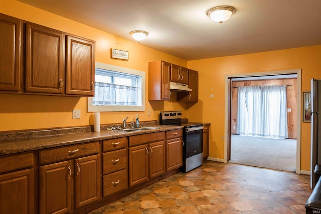 kitchen featuring light carpet, sink, and stainless steel range with electric cooktop