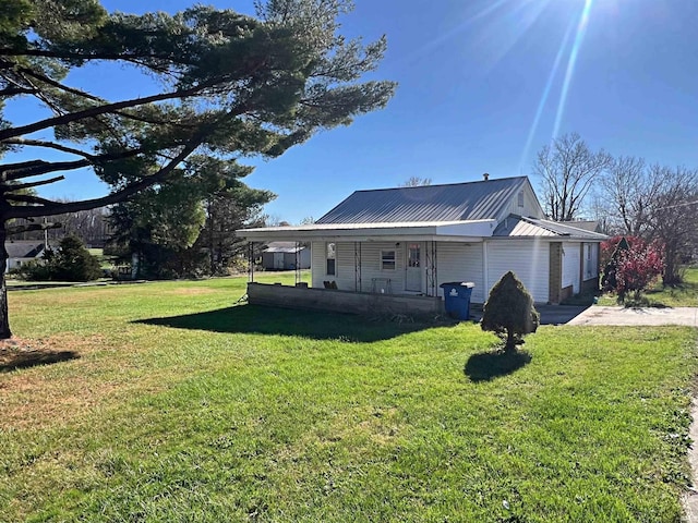 exterior space featuring covered porch and a yard