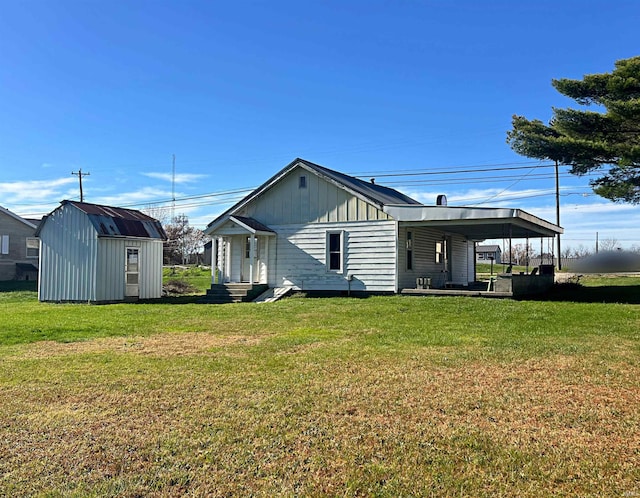 view of side of property with a lawn and a storage unit