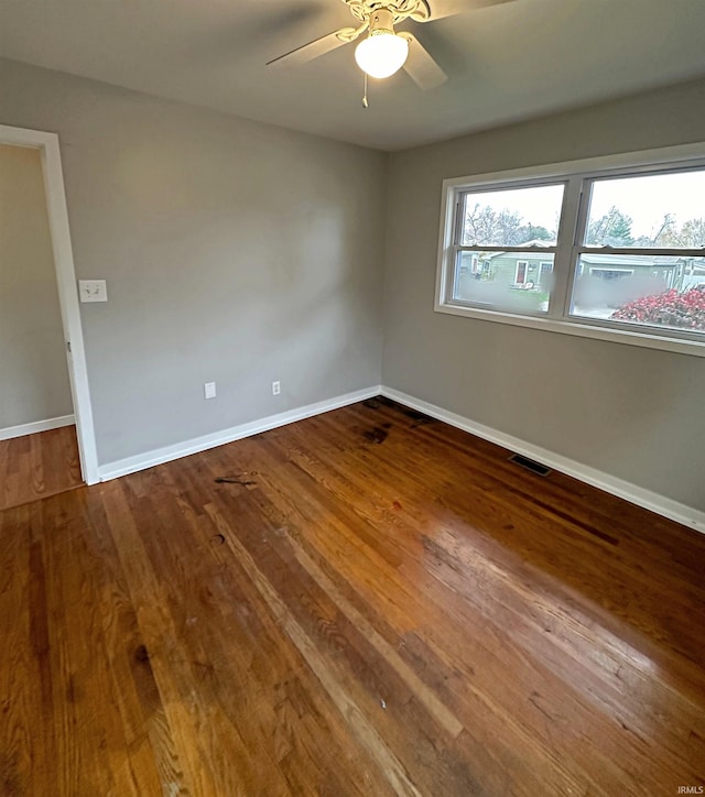 spare room with hardwood / wood-style flooring and ceiling fan