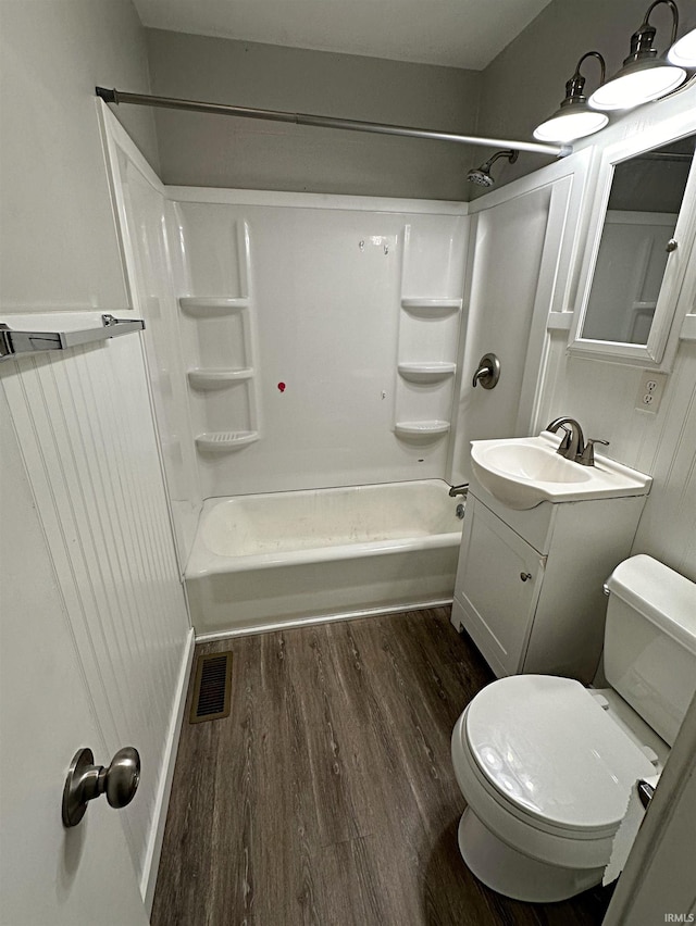 full bathroom with toilet, vanity, hardwood / wood-style flooring, and bathing tub / shower combination