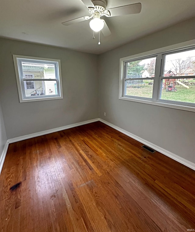 empty room featuring hardwood / wood-style floors and ceiling fan