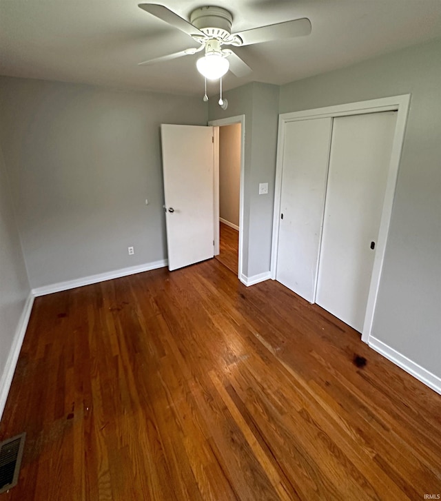 unfurnished bedroom featuring wood-type flooring, a closet, and ceiling fan