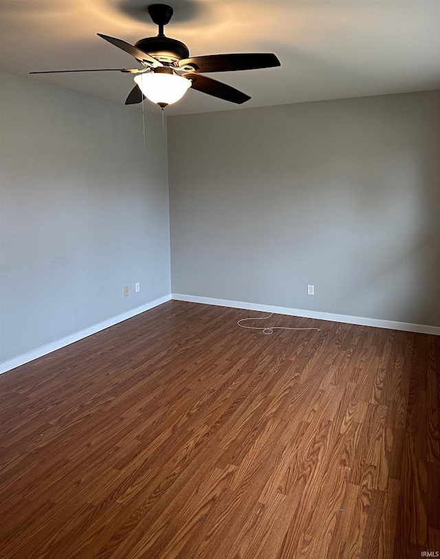 empty room with dark hardwood / wood-style floors and ceiling fan