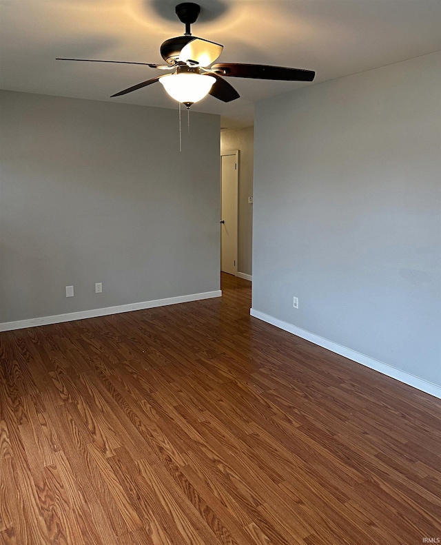 spare room with ceiling fan and wood-type flooring