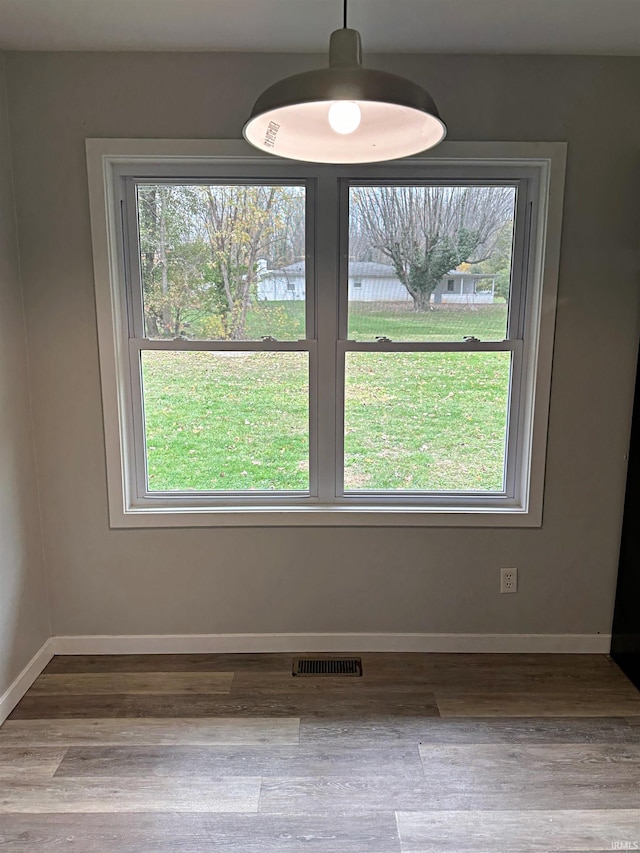 unfurnished dining area featuring hardwood / wood-style flooring