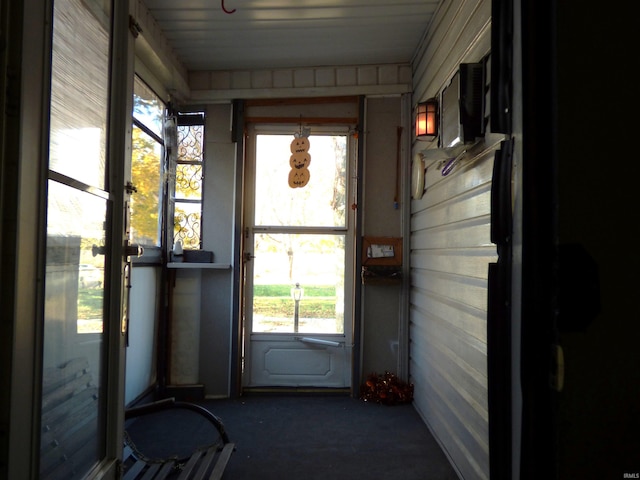 entryway featuring wooden walls