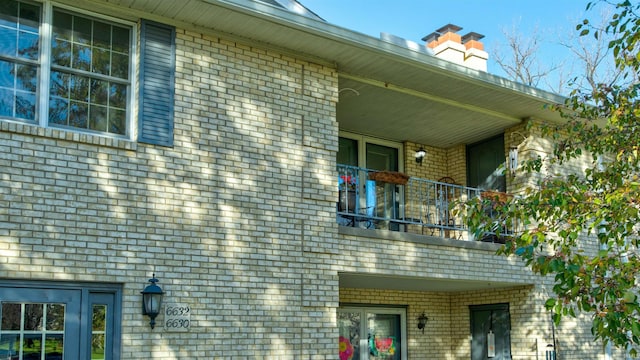 view of side of home featuring a balcony