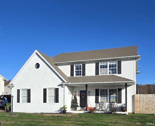 view of front of home with covered porch and a front yard