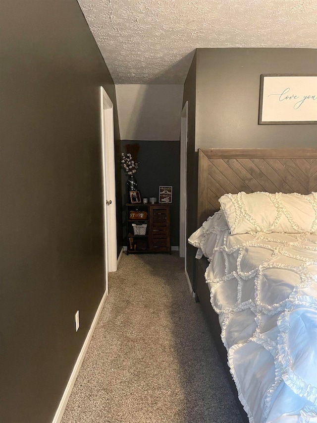 carpeted bedroom with a textured ceiling