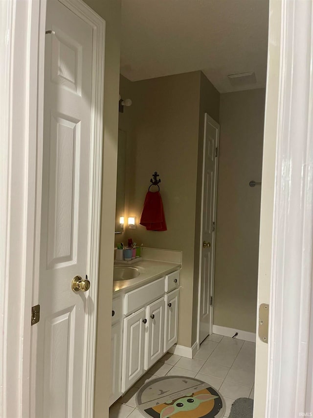 bathroom with tile patterned floors and vanity