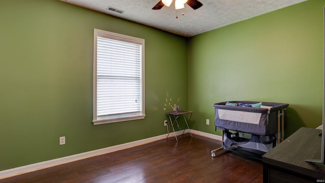 miscellaneous room featuring wood-type flooring, a textured ceiling, and ceiling fan