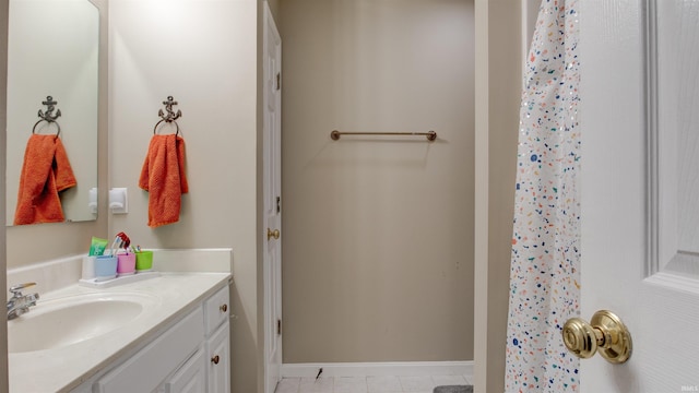 bathroom featuring vanity, tile patterned floors, and walk in shower