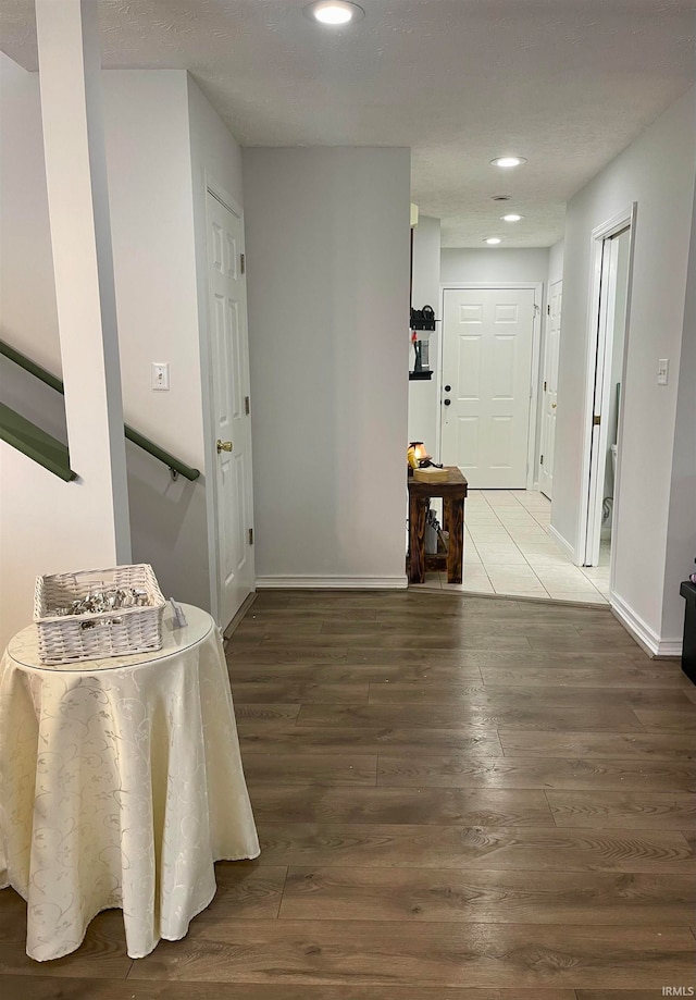 corridor with wood-type flooring