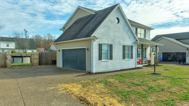 view of side of home featuring a yard and a garage