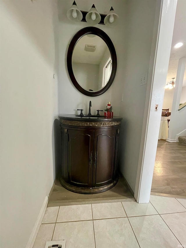 bathroom featuring tile patterned flooring and vanity