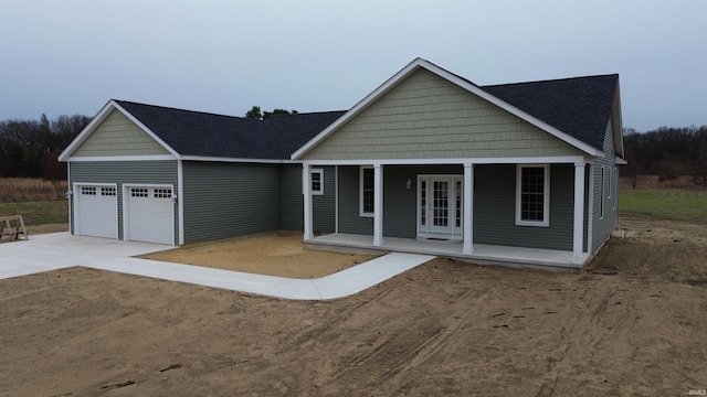 view of front of property with a porch and a garage