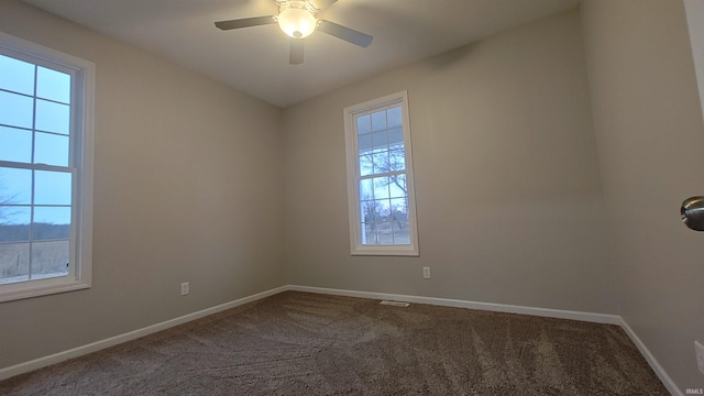 unfurnished room featuring carpet flooring, plenty of natural light, and ceiling fan