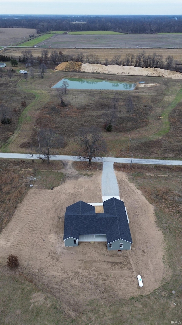 birds eye view of property featuring a water view and a rural view